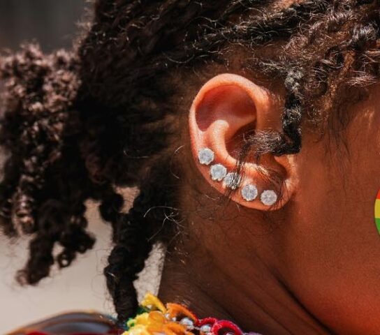 Portrait of a Black woman at a pride parade. Photo by Mike Cox on Unsplash