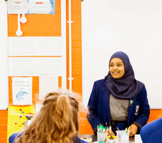Woman standing in front of a class.