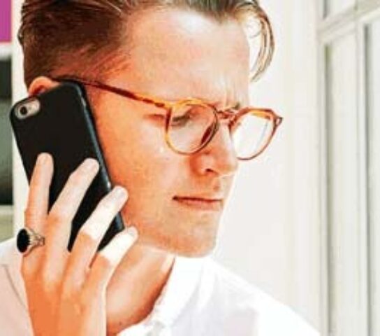 Employee in the Stonewall office on the phone