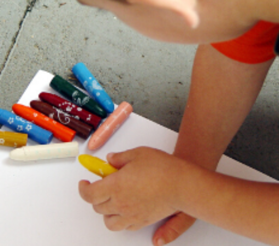 A child with some crayons.