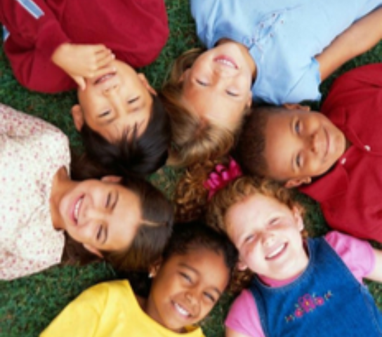 A group of children lying in a circle.