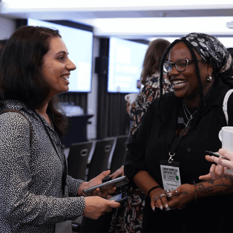 Three people talking at a conference square crop