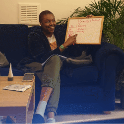 Person holding up a whiteboard with words on it