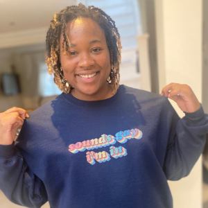 Person smiling and wearing a t shirt that reads 'sounds gay, I'm in.'