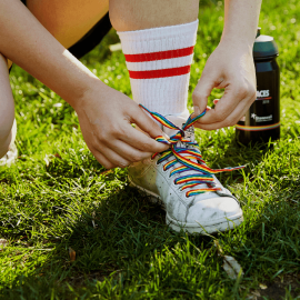 Person wearing rainbow laces in shoes