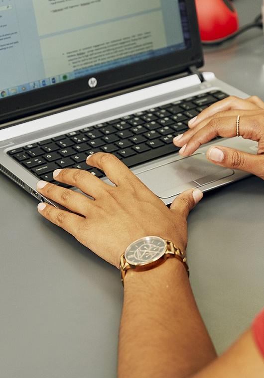 Hands on laptop keyboard