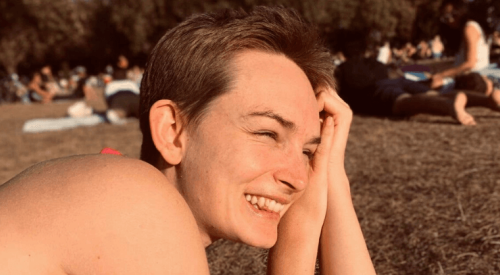 Person smiling in a sunny park