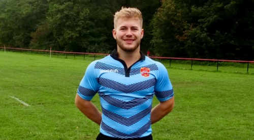 Person in a rugby uniform in a field