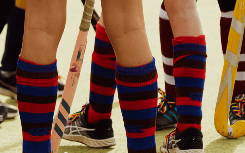 Group of young people playing sport wearing rainbow laces