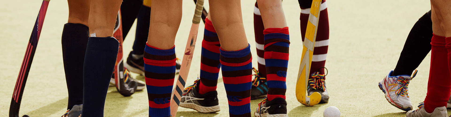 Group of young people playing sport wearing rainbow laces